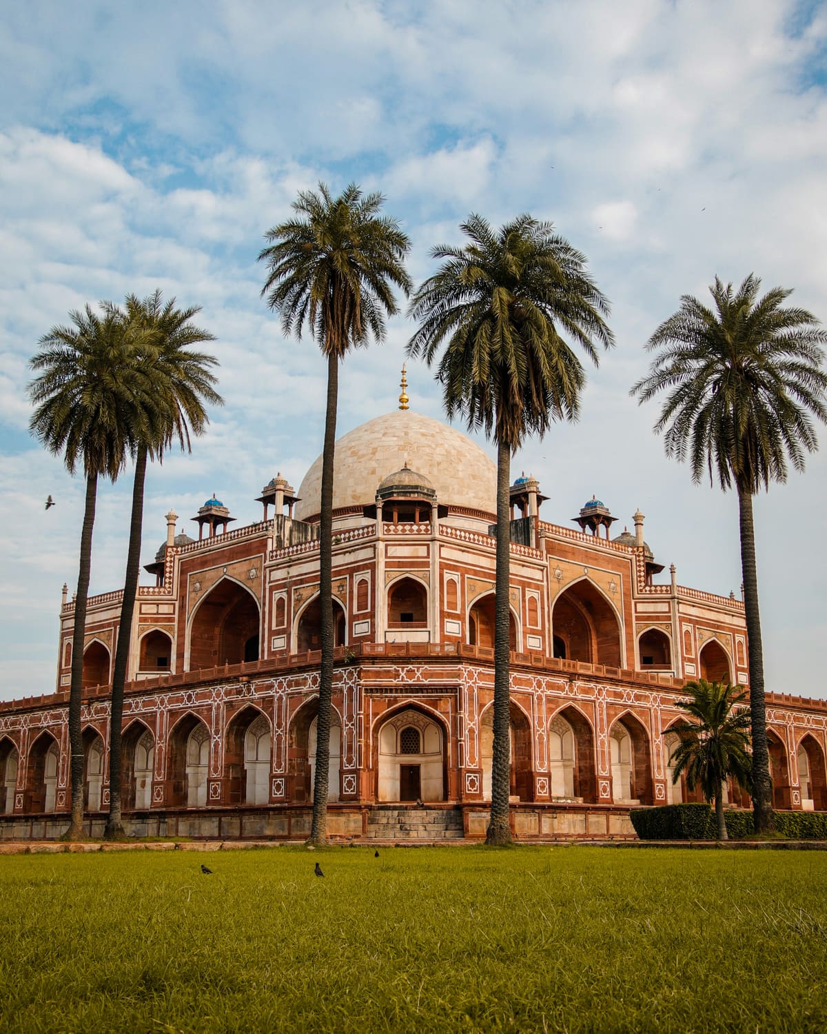 Humayun's Tomb framed by palms in Delhi, a stop on Gamana's heritage audio tour