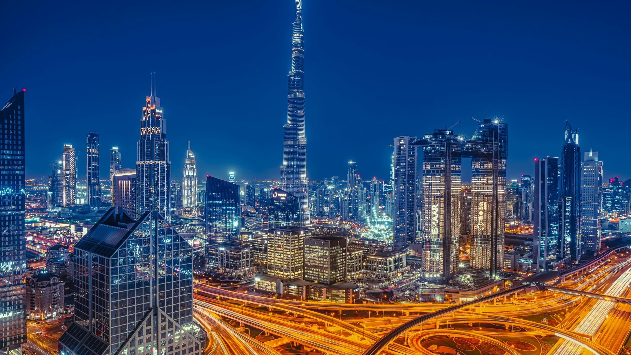 The Burj Khalifa above the illuminated Dubai skyline at night