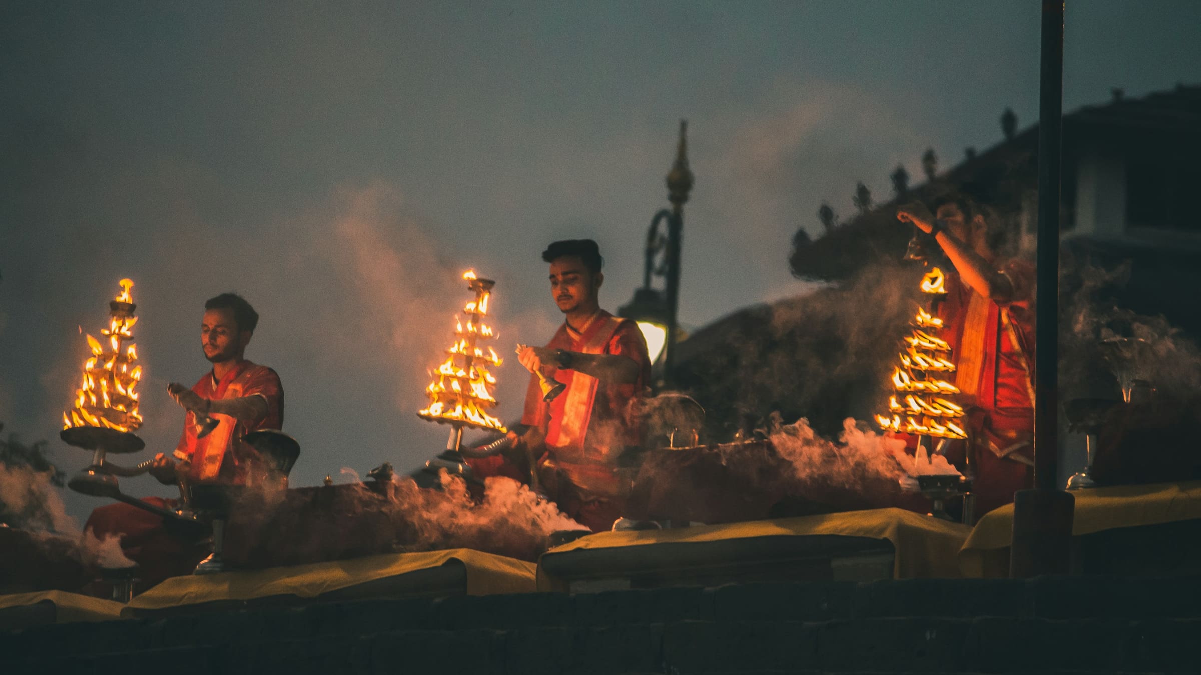Priests performing the evening Ganga Aarti with brass lamps on the Varanasi ghats